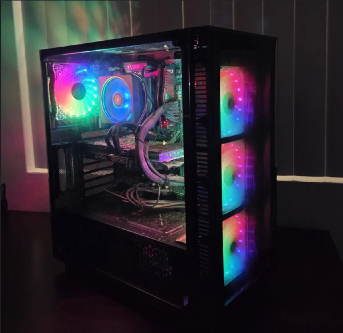RGB gaming PC shown from a three-quarter angle with its components visible through the side panel