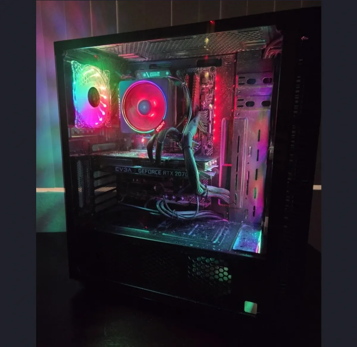 Interior view of an RGB gaming PC showing the graphics card, motherboard, cooling, and cabling